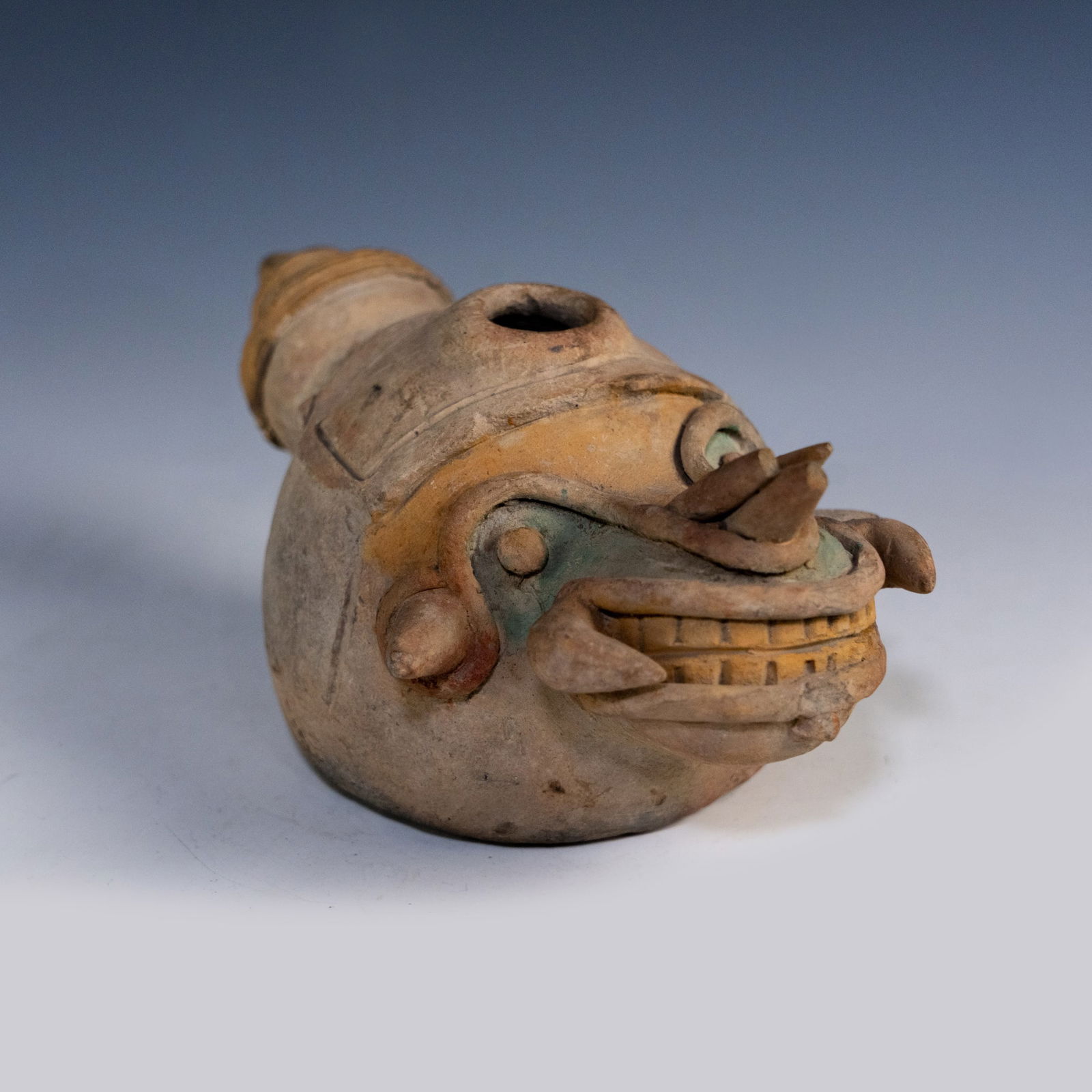 Pre-Columbian Jamacoaque Zoomorphic Whistle Effigy: A Pre-Columbian Jamacoaque zoomorphic clay whistle or ocarina effigy c. 300 BC - 400 AD in the shape form of a mythic creature with tusks and a wide grimace having three tone holes on underside. Prove
