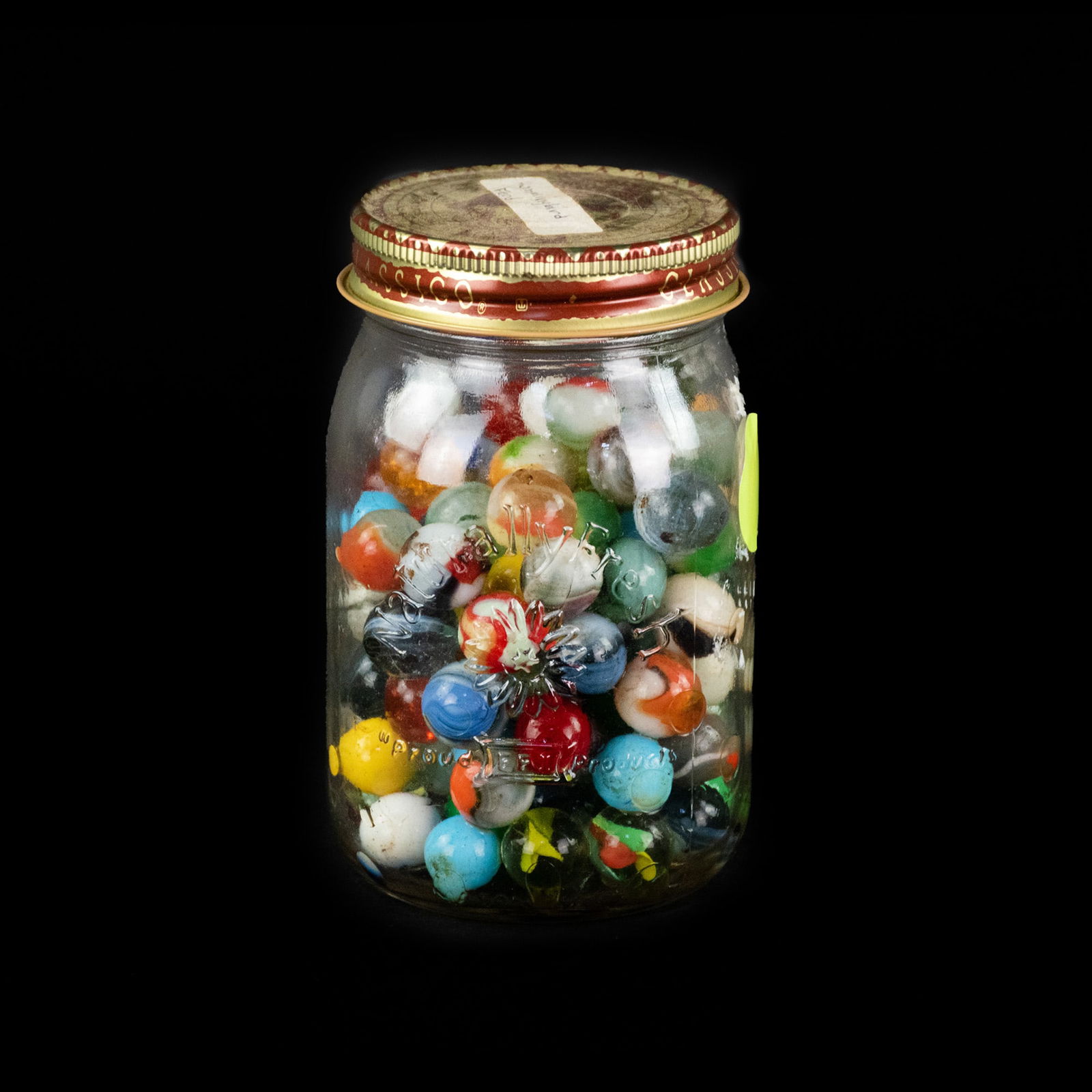 Jar of Vintage Glass Marbles: A jar of vintage and antique glass marbles varying in color.