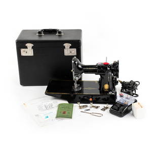 1958 Singer 221K 'Featherweight' Portable Sewing Machine: A 1958 black Singer 221K 'Featherweight' portable sewing machine with various accessories including the original carrying case, extra spools of thread, motor controller, additional feet and manual. Un