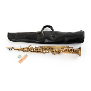 C.G. Conn Ltd Brass Soprano Saxophone: A C.G. Conn Ltd. brass soprano low pitch saxophone marked with the serial number M169675 with mother of pearl accents. Includes mouthpiece, a black leather case, a tin of micro cork grease, and two re