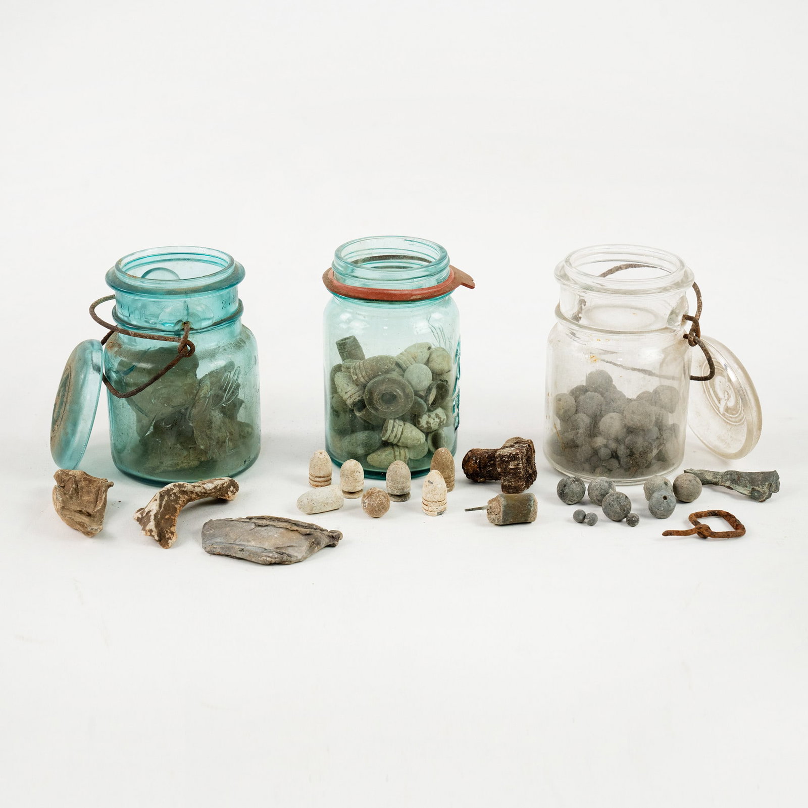 Group of US Civil War Minie Balls and Other Bullets: A group of three (3) clear Mason canister jar filled with minie balls, other various bullets and components ranging in size and material, approximately 50-75 pieces per jar. Recovered in the 1990s. Pr