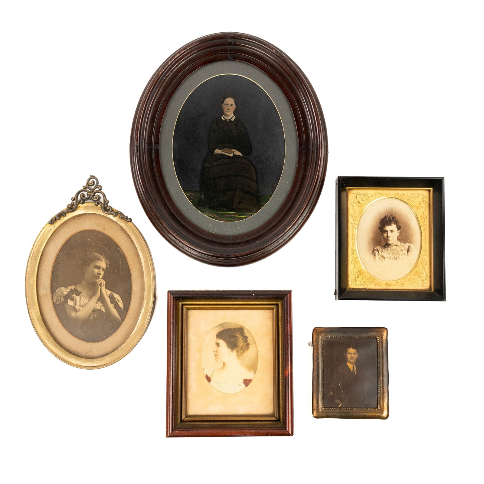 (5) Grouping of 20th Century Framed Portraits: A grouping of (5) portraits including four photographic portraits: one of a man in a suit and tie in a gold plated frame, one of a young woman in a striped dress in a black frame with gold matting, on