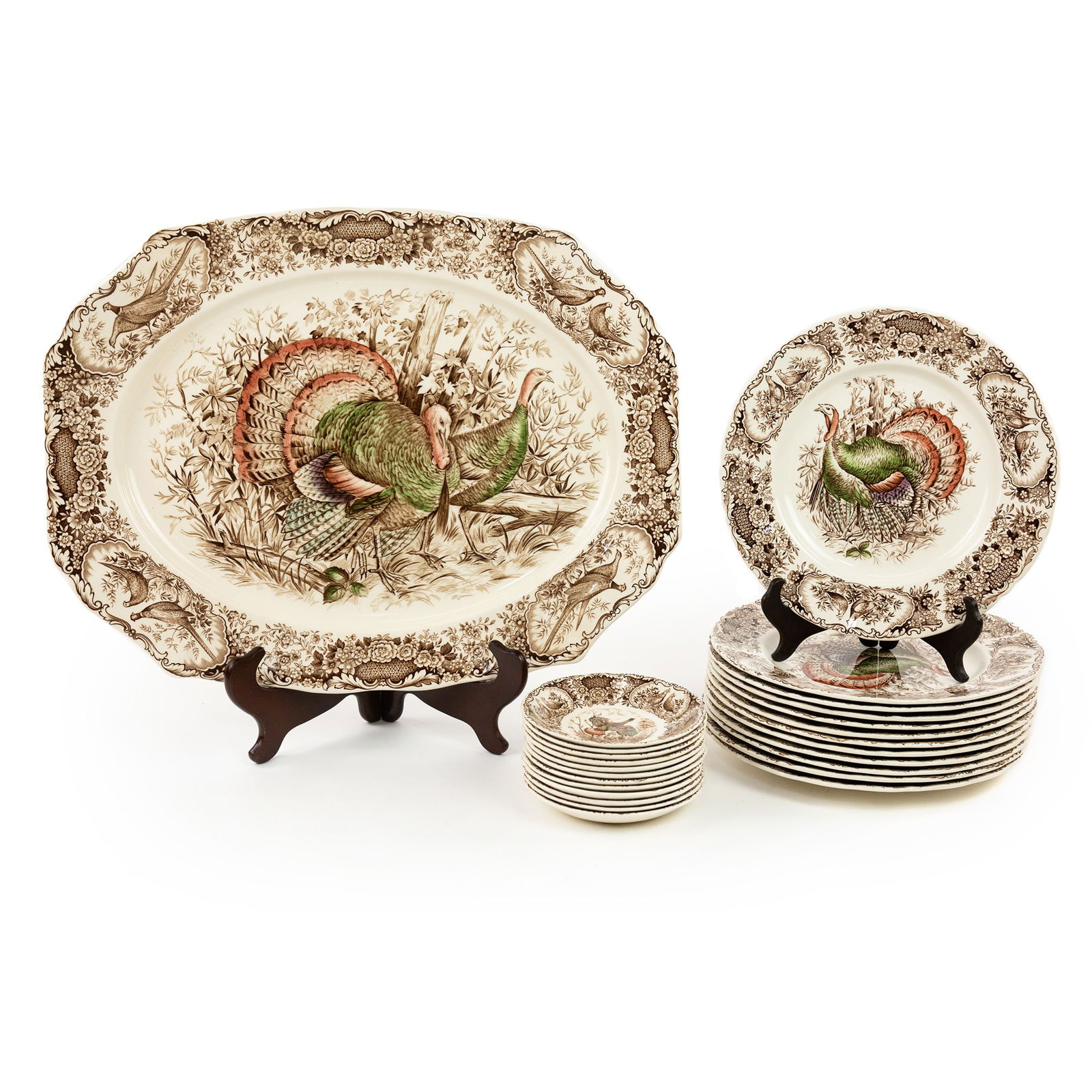 Johnson Bros Wild Turkey Native American Serveware Set: A set of Johnson Bros Wild Turkey Native American 25-piece serveware set including: 12 each of dinner plates and bowls, and a serving platter. Each featuring depictions of turkeys around the rim and i