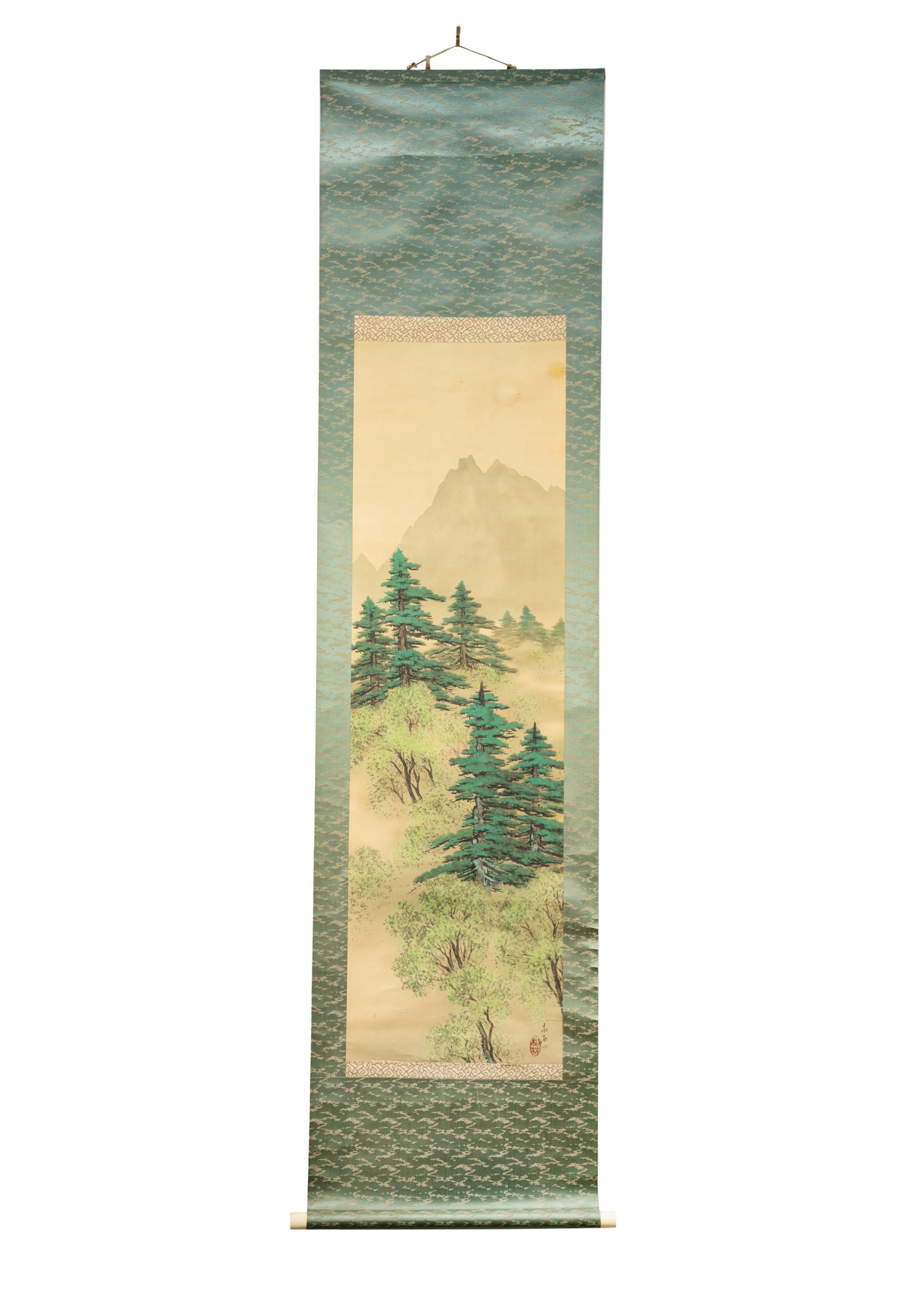 Chinese Spring Mountain Painting on Silk Scroll: A Chinese painting on a silk scroll with inscription and possible signature stamps at the lower right corner, and having a bone roller, and featuring a painted depiction of a springtime mountain lands