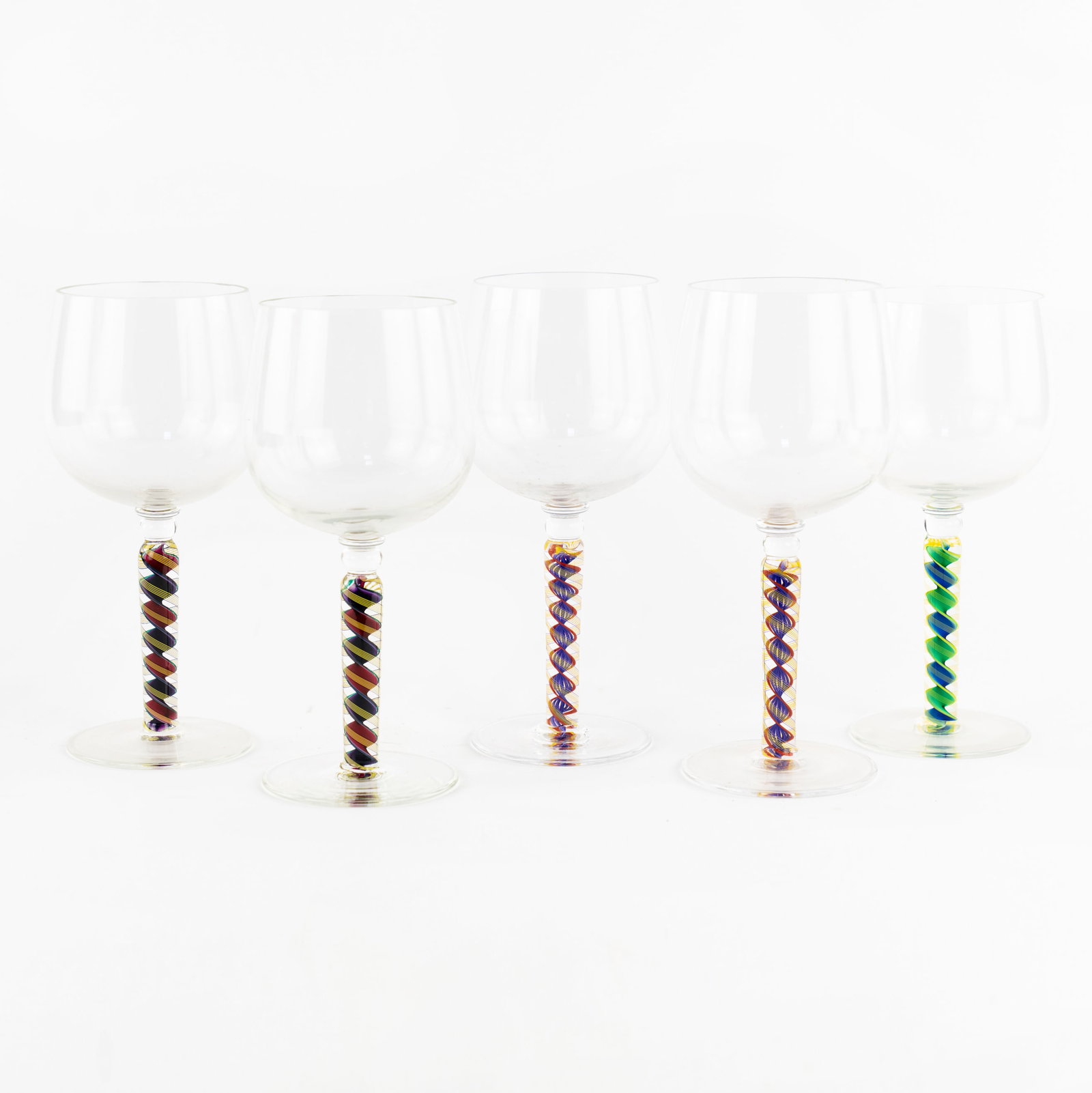 (5) Set of Nadal Art Glass Wine Glasses: Artist Name: James Nadal Studio: Nadal Glass Location: Canandaigua, New York Medium: Studio art glass Description: A set of (5) hand blown art glass wine glasses with spiral motif stems. Each incised