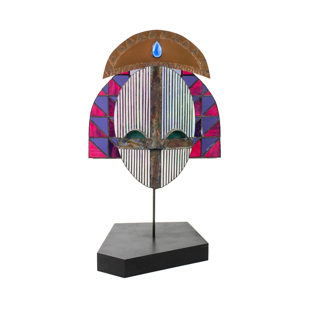 Vintage Stained Glass Bakota Mask on Stand Signed: A vintage stained glass Gabon style Bakota fused art glass mask on stand having metal crown with jewels and multicolored mask. Black metal stand included. Signed Betty Haums.