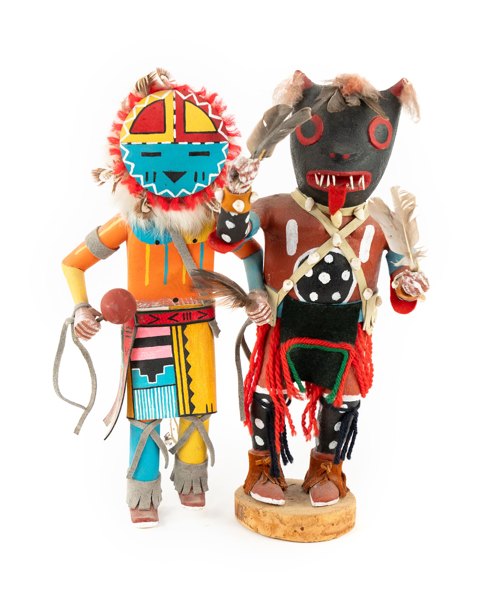 Pair of Reproduction Wooden Hand Carved Kachina Dolls: A pair of reproduction wooden Kachina dancer dolls likely for tourist trade; each having leather, felt and feather or fur adornments. Both unsigned. Measurements are for larger figure.