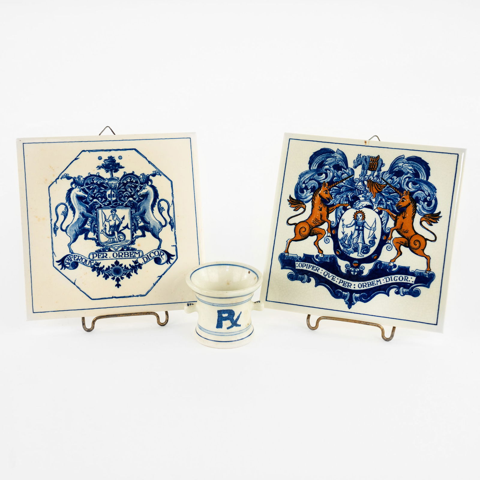 (3) Group of Delft Porcelain Apothecary's Smalls: A group of (3) Delft porcelain apothecary smalls including: two pill tiles both featuring art with apothecary motifs, and a Squibb RX mini mortar. Each marked on verso or underside. Measurements are f