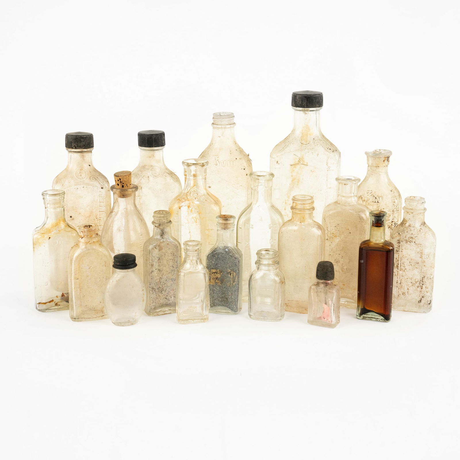 Collection of Antique Assorted Glass Bottles: A collection of assorted antique glass bottles, flasks and vials in varying shapes and sizes.