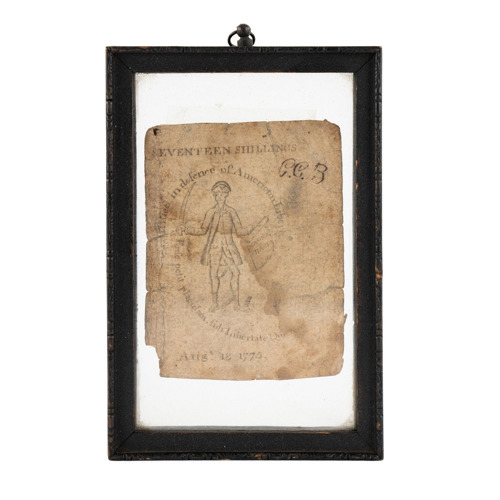 Paul Revere Massachusetts 17-Shilling Note: A Massachusetts 17-shilling note engraved and printed by Paul Revere in 1775. Presented in a double sided black frame having a small hanging loop at the top. Frame: 4" x 6"