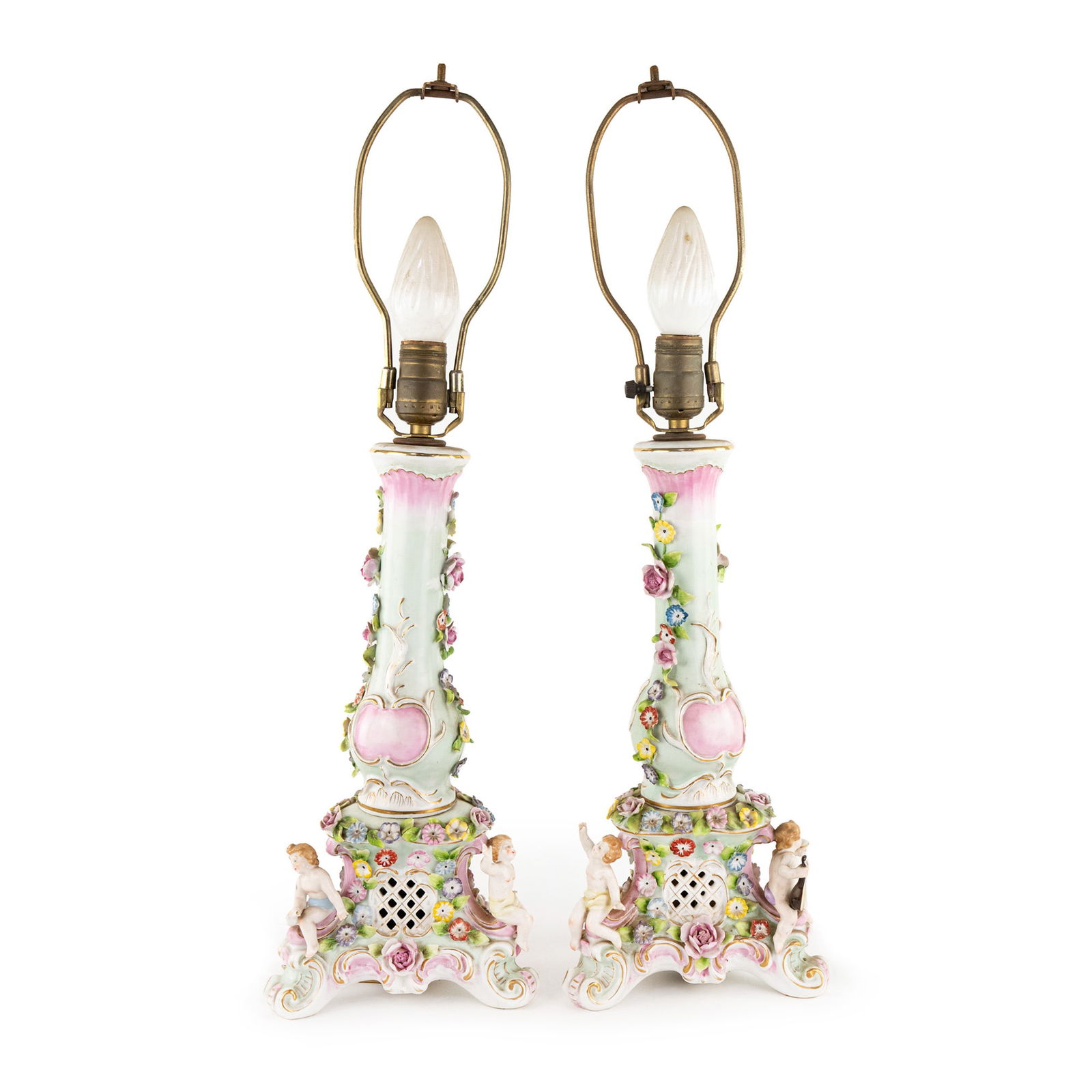 Pair of Italian Capodimonte Porcelain Table Lamps: A pair of Italian Capodimonte porcelain table lamps each featuring depictions of cherubs at the base and floral motifs throughout. SHIPPING Atlanta Auction Gallery will NOT ship this lot in-house. The