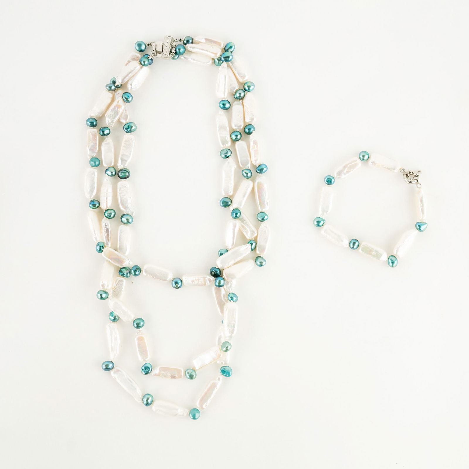 Freshwater Pearl Necklace and Bracelet Set: A set of freshwater pearl jewelry including a three strand necklace and a bracelet; each having blue pearls separated by beads of mother of pearl and a steel clasp. PICK UP The FINAL day to collect it