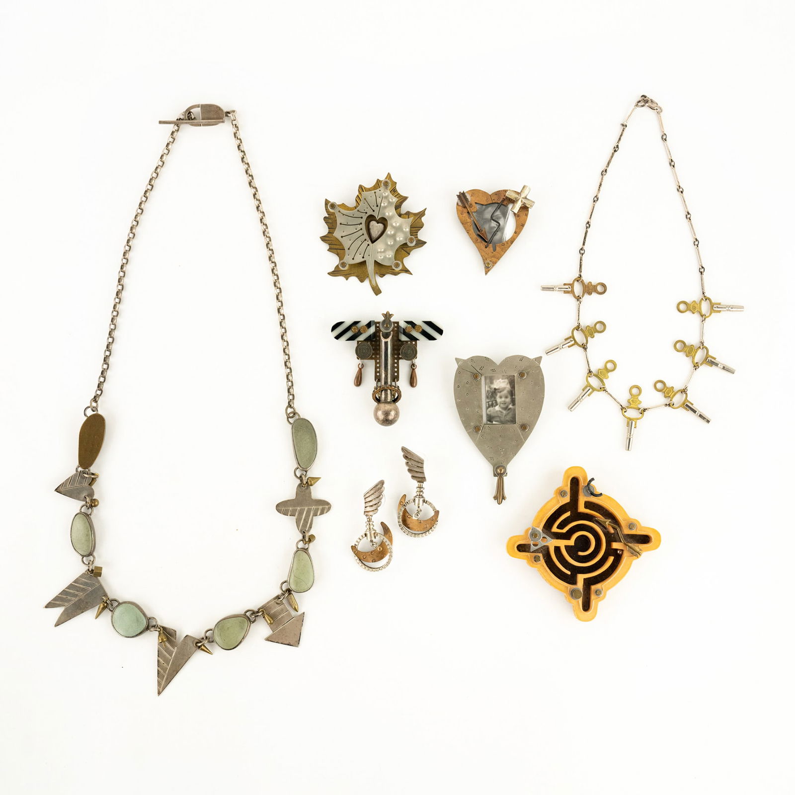 (8) Grouping of Thomas Mann & Techno Romantic Jewelry: A grouping of (8) designer jewelry pieces by Thomas Mann and Techo Romantic in varying styles including five brooches, two necklaces, and a pair of earrings. Each stamped on verso. PICK UP The FINAL d