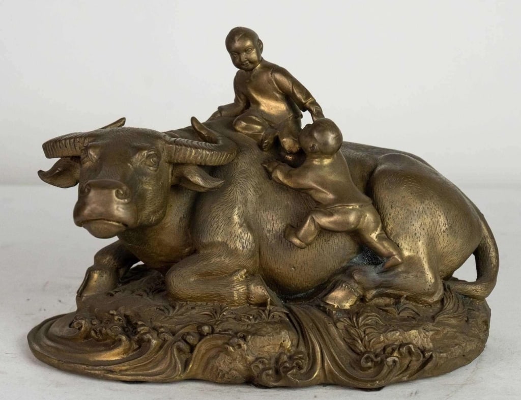 CHINESE SCULPTURE OF TWO CHILDREN AND A BULL: Chinese sculpture of two children and a bull 20th c. Note: Each lot in this auction was stored in an active industrial warehouse. Accordingly, lots may exhibit dust and/or surface residue and may bene