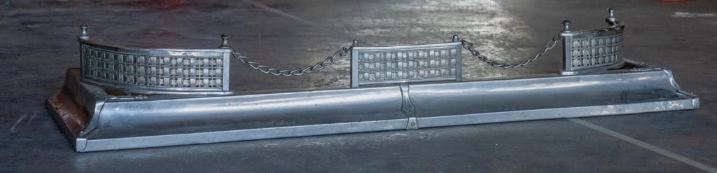 ART DECO VINTAGE SILVER FIREPLACE FENDER: Art deco vintage silver fireplace fender probably aluminum. Note: Each lot in this auction was stored in an active industrial warehouse. Accordingly, lots may exhibit dust and/or surface residue and m
