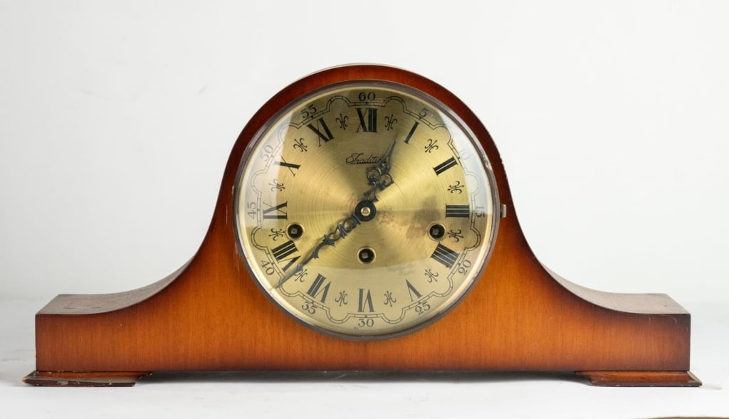 TRADITION VINTAGE MAHOGANY MANTLE CLOCK: Tradition vintage mahogany mantle clock. Note: Each lot in this auction was stored in an active industrial warehouse. Accordingly, lots may exhibit dust and/or surface residue and may benefit from cle