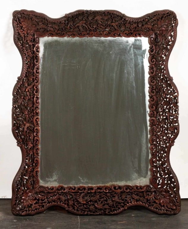 INDIAN STYLE FILIGREE CARVED WOOD WALL MIRROR: Filigreed carved wood wall mirror. Note: Each lot in this auction was stored in an active industrial warehouse. Accordingly, lots may exhibit dust and/or surface residue and may benefit from cleaning.