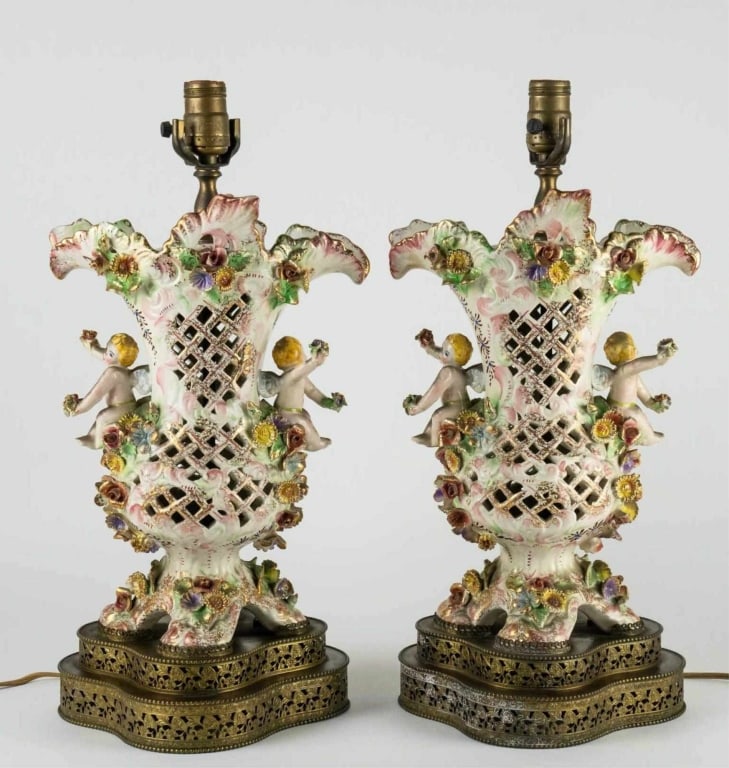CAPODIMONTE STYLE PARCEL-GILT PORCELAIN LAMPS: Pair of Capodimonte style parcel-gilt lamps hand-painted, porcelain. Note: Each lot in this auction was stored in an active industrial warehouse. Accordingly, lots may exhibit dust and/or surface resi