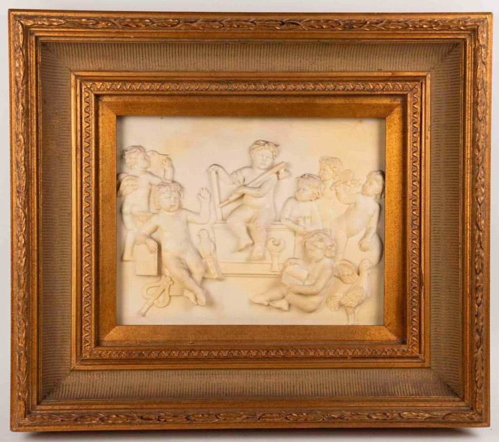 ITALIAN PUTTI RELIEF PLAQUE: Depicting a tavern revelry with a dancing carved composite relief plaque of putti at play with musical and scholarly attributes in classical taste presented in a gilt frame apparently unsigned likely 
