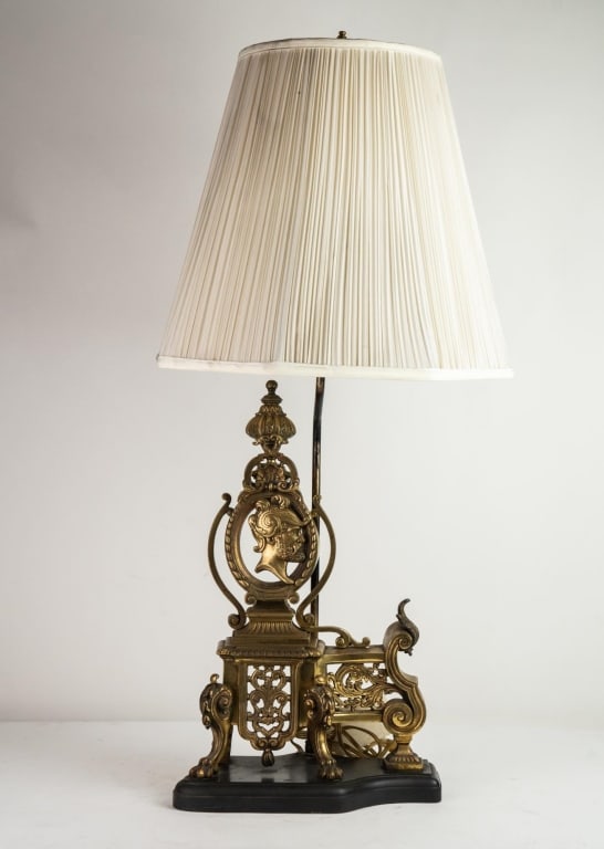FRENCH FILIGREE BRASS FIREPLACE ANDIRON LAMP: Filigree cast brass fireplace andiron lamp. Note: Each lot in this auction was stored in an active industrial warehouse. Accordingly, lots may exhibit dust and/or surface residue and may benefit from