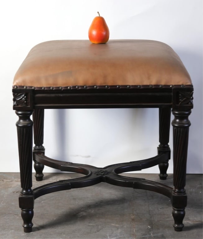 FRENCH LEATHER TOP NAILHEAD TRIM OTTOMAN: French leather top w/ nailhead trim ottoman cross stretcher. Note: Each lot in this auction was stored in an active industrial warehouse. Accordingly, lots may exhibit dust and/or surface residue and 