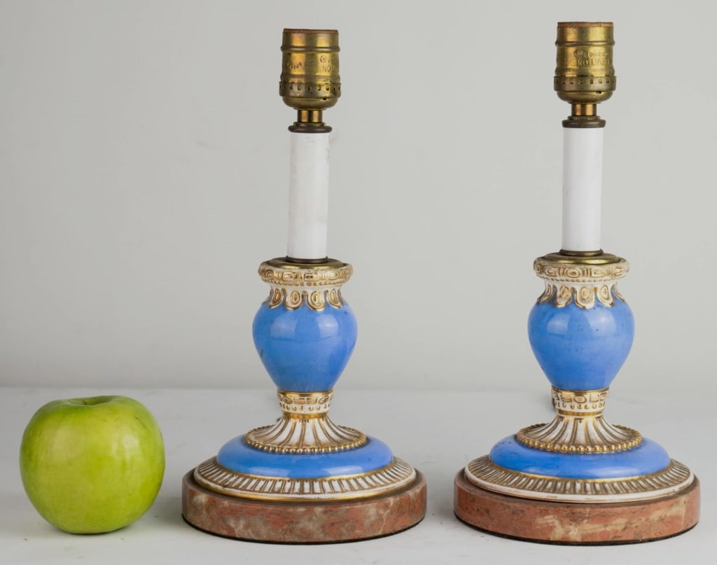 FRENCH PORCELAIN CANDLESTICKS CONVERTED TO LAMPS: Pair of porcelain candlesticks converted to lamps. Note: Each lot in this auction was stored in an active industrial warehouse. Accordingly, lots may exhibit dust and/or surface residue and may benefi