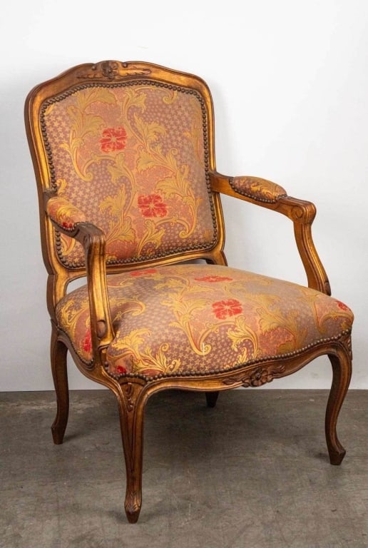 FRENCH PROVINCIAL STYLE CARVED ARMCHAIR: French provincial style carved armchair. Note: Each lot in this auction was stored in an active industrial warehouse. Accordingly, lots may exhibit dust and/or surface residue and may benefit from cle