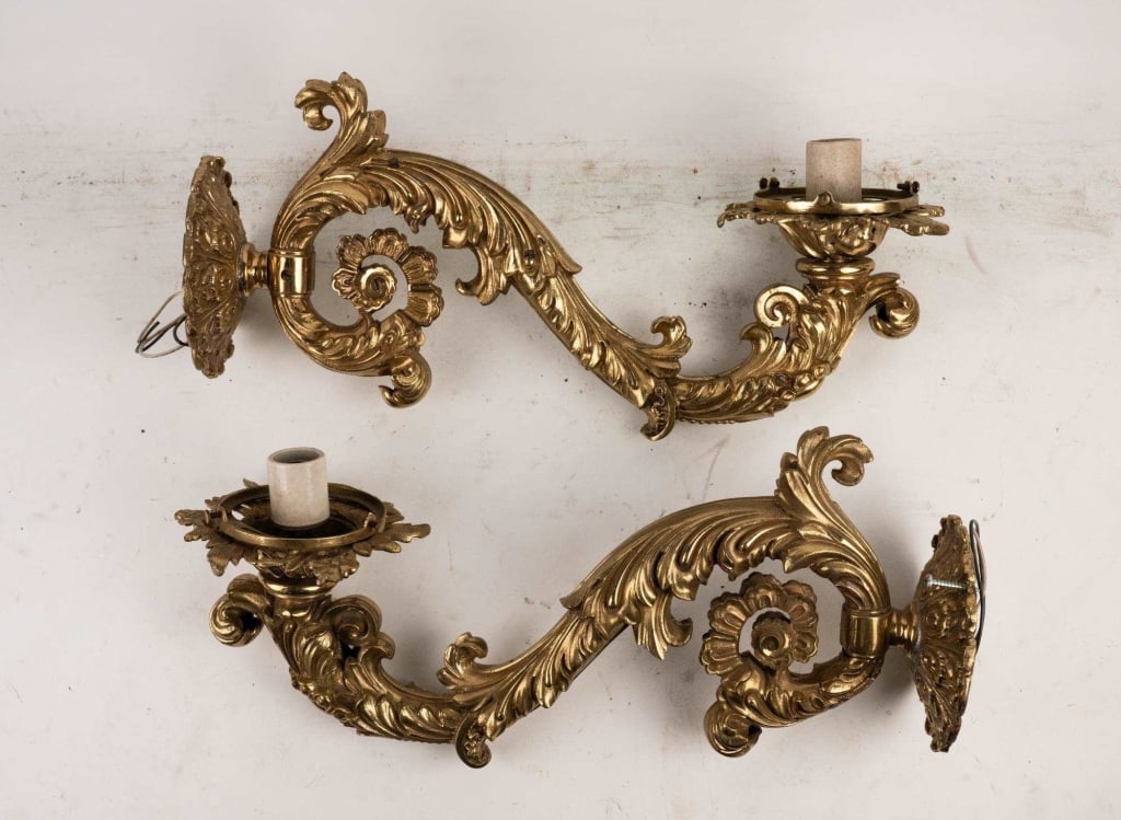 ITALIAN ORNATE GILT METAL ONE ARM WALL SCONCES: Italian ornate gilt metal one arm wall sconces. Note: Each lot in this auction was stored in an active industrial warehouse. Accordingly, lots may exhibit dust and/or surface residue and may benefit f