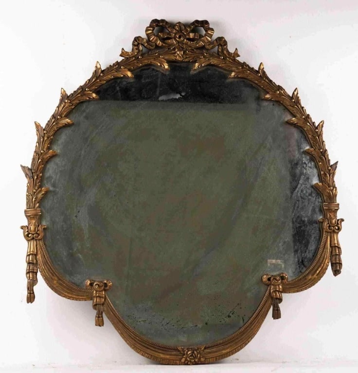 FRENCH CARVED WALL MIRROR: French carved wall mirror. Note: Each lot in this auction was stored in an active industrial warehouse. Accordingly, lots may exhibit dust and/or surface residue and may benefit from cleaning. Approxi