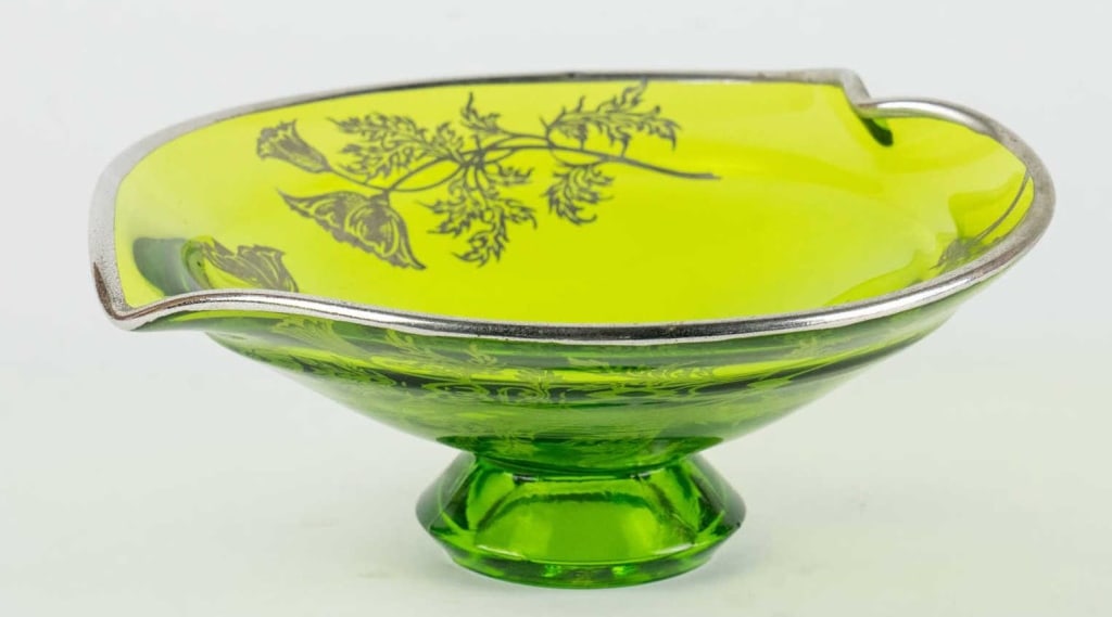 STERLING OVERLAY FOOTED CALYX BOWL: Vintage sterling overlay footed calyx bowl. Note: Each lot in this auction was stored in an active industrial warehouse. Accordingly, lots may exhibit dust and/or surface residue and may benefit from 
