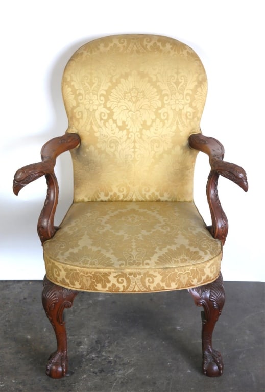 IRISH CHIPPENDALE CROOKED ARM STYLE CHAIR: With a shell knee carving and claw foot. Some discoloration and wear on upholstery. Note: Each lot in this auction was stored in an active industrial warehouse. Accordingly, lots may exhibit dust and/