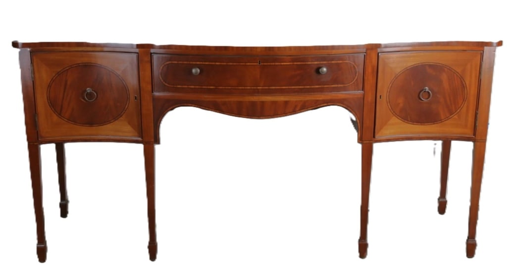 ENGLISH MAHOGANY INLAID SERPENTINE SIDEBOARD: English Mahogany inlaid serpentine sideboard. Note: Each lot in this auction was stored in an active industrial warehouse. Accordingly, lots may exhibit dust and/or surface residue and may benefit fro