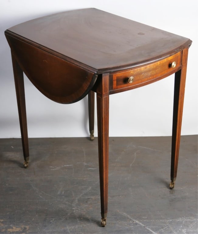ENGLISH MAHOGANY INLAY & BANDED PEMBROKE TABLE: Mahogany inlay and banded pembroke table caster legs. Note: Each lot in this auction was stored in an active industrial warehouse. Accordingly, lots may exhibit dust and/or surface residue and may ben