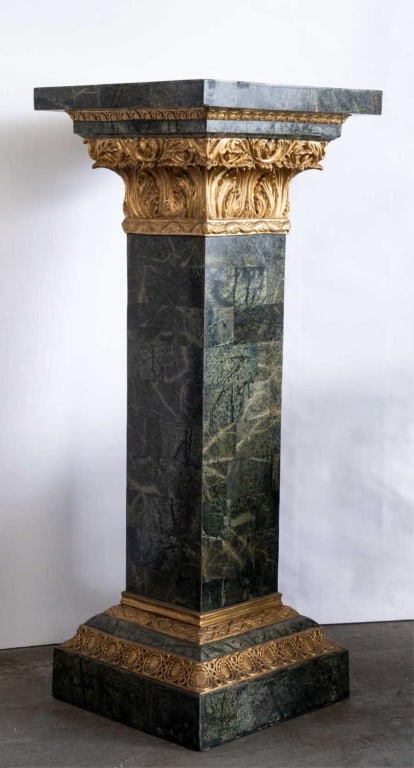 GREEN MARBLE PEDESTAL WITH GILT CAPITAL AND ACCENT: Green marble pedestal with Gilt capital and accents. Note: Each lot in this auction was stored in an active industrial warehouse. Accordingly, lots may exhibit dust and/or surface residue and may bene