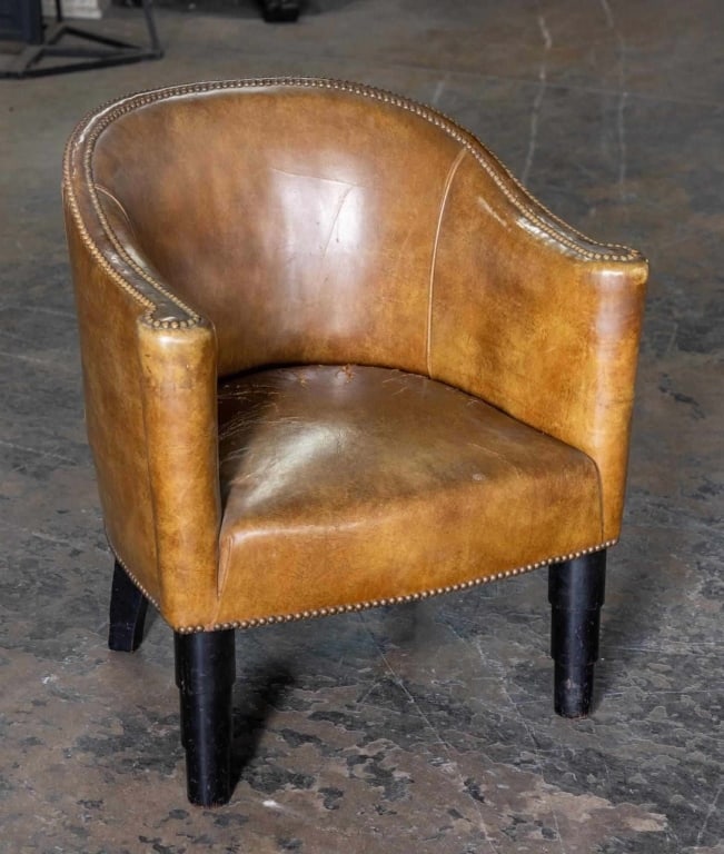 ENGLISH ANTIQUE DISTRESSED LEATHER BARREL CHAIR: Tripod leg, nail head trim, heavily distressed leather barrel-back. Note: Each lot in this auction was stored in an active industrial warehouse. Accordingly, lots may exhibit dust and/or surface resid