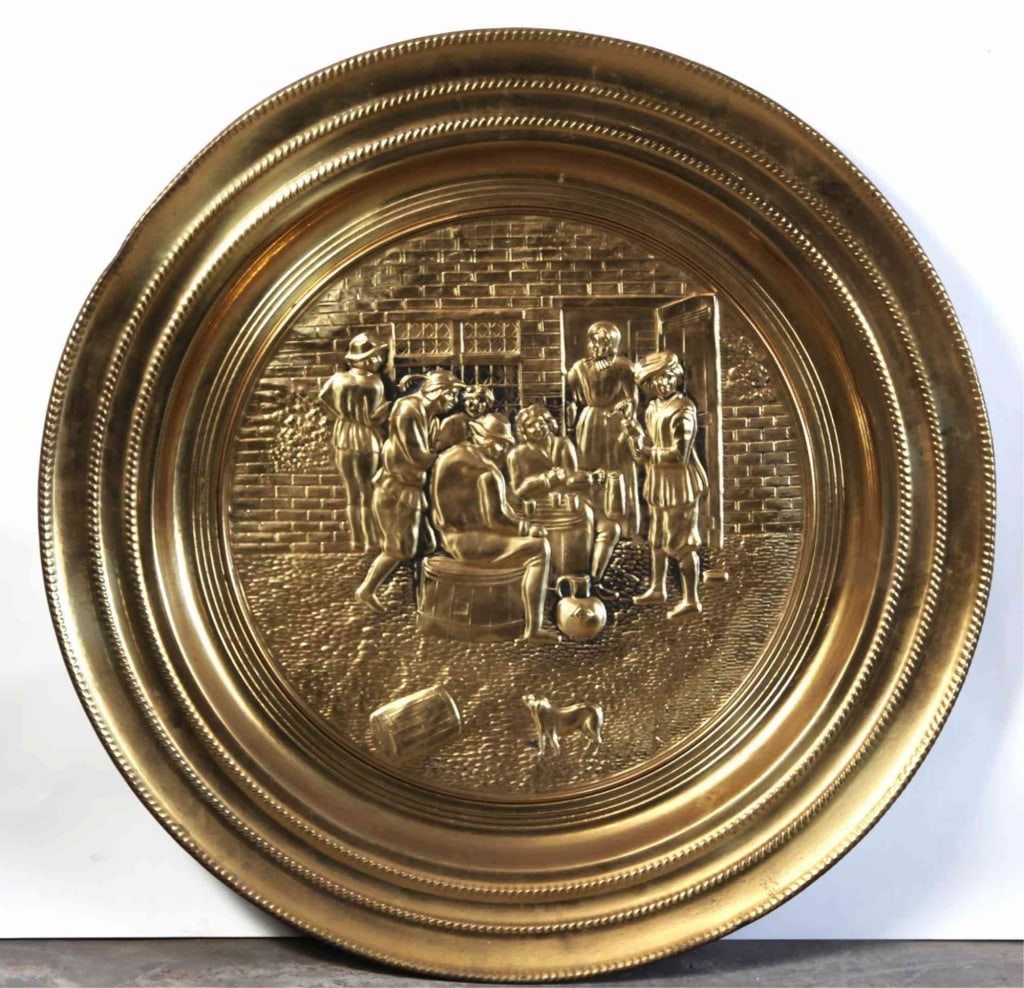 ENGLISH BRASS MONUMENTAL FIGURAL CHARGER: English brass monumental figural charger. Note: Each lot in this auction was stored in an active industrial warehouse. Accordingly, lots may exhibit dust and/or surface residue and may benefit from cl