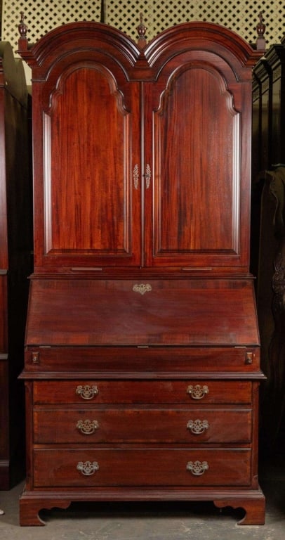 ENGLISH STYLE MAHOGANY DOUBLE BONNET SECRETAIRE: English style Mahogany fitted slant-front secretary. Note: Each lot in this auction was stored in an active industrial warehouse. Accordingly, lots may exhibit dust and/or surface residue and may bene