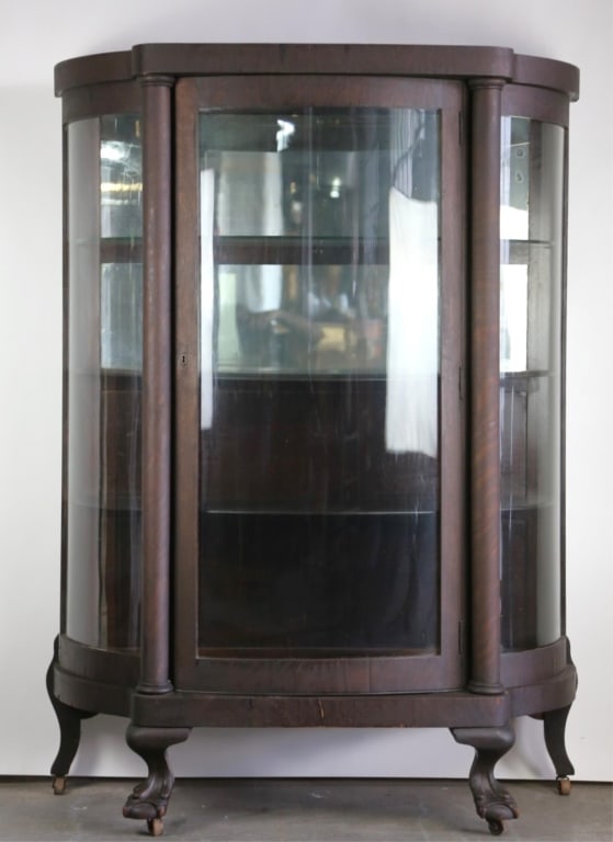 AMERICAN CHIPPENDALE STYLE OAK BOW FRONT VITRINE: American Chippendale style oak bow front vitrine. Note: Each lot in this auction was stored in an active industrial warehouse. Accordingly, lots may exhibit dust and/or surface residue and may benefit
