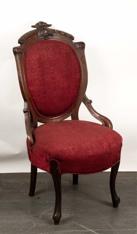 VICTORIAN HAND CARVED CHAIR W/ BURGUNDY UPHOLSTERY: Victorian hand carved chair w/ burgundy upholstery. Note: Each lot in this auction was stored in an active industrial warehouse. Accordingly, lots may exhibit dust and/or surface residue and may benef