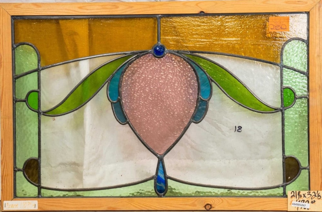 FRENCH ART NOUVEAU JEWELED STAINED GLASS PANEL: French Art Nouveau jeweled stained glass panel with a heart-shaped medallion, blue jeweled detail, and blue wispy glass accent. Approximate dimensions: h. 21.5", w. 32.5" Disclaimer: This is an online