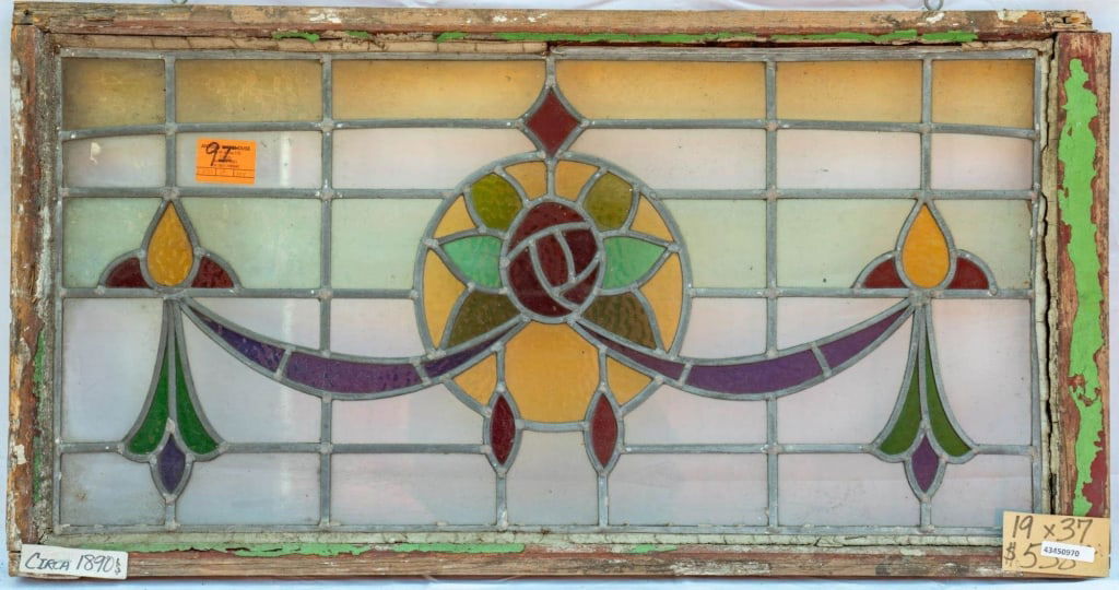 FRENCH ART NOUVEAU STAINED GLASS PANEL: French Art Nouveau stained glass panel with a floral and ribbon motif set within leaded stained glass panels. Approximate dimensions: h. 19", w. 37" Disclaimer: This is an online court ordered bankrup