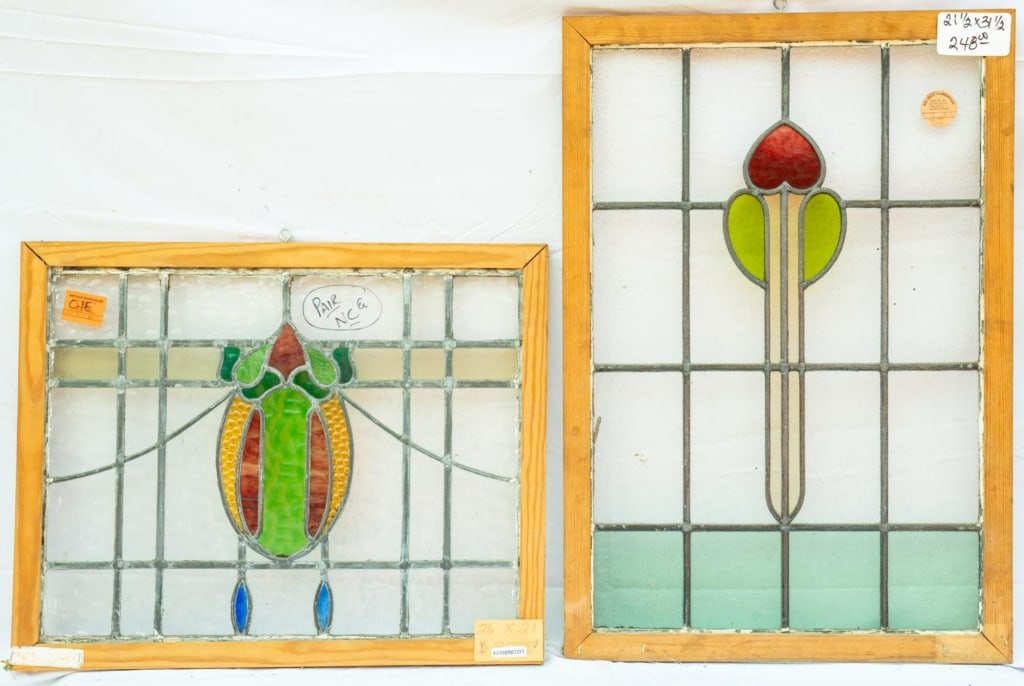 TWO FRENCH ART NOUVEAU STAINED GLASS PANELS: Two French Art Nouveau stained glass panels with green and red floral motif accents. Approximate dimensions: h. 31.5", w. 21.5" Disclaimer: This is an online court ordered bankruptcy sale. Participati