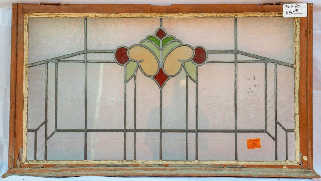 FRENCH ART NOUVEAU STAINED GLASS PANEL: French Art Nouveau stained glass panel with a floral stained glass medallion set within colorless textured leaded glass panels. Approximate dimensions: h. 26", w. 46" Disclaimer: This is an online cou