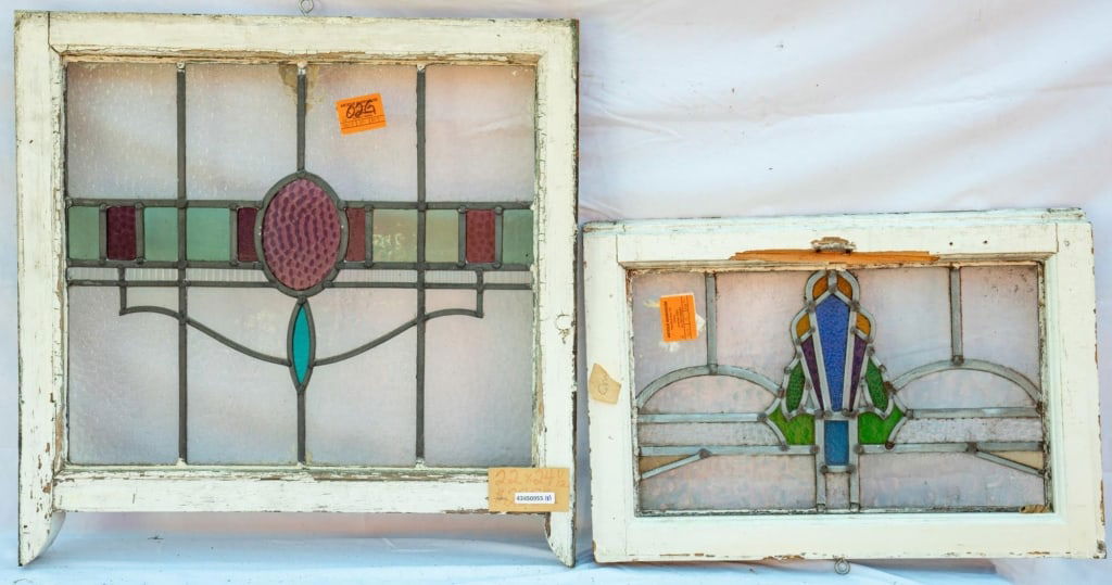 TWO CONTINENTAL STAINED GLASS PANELS: Two Continental stained glass panels with a geometric motif set within leaded stained glass panels. Approximate dimensions: h. 24.5", w. 22" Disclaimer: This is an online court ordered bankruptcy sale
