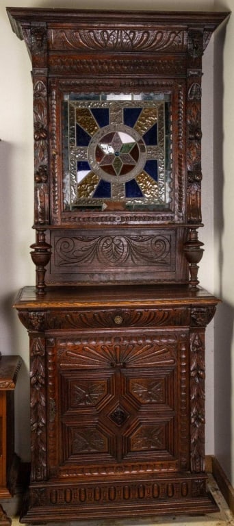 FRENCH RENAISSANCE REVIVAL STAINED GLASS BUFFET: French Renaissance Revival stained glass buffet with carved lion head accents, and elaborately carved details. Approximate dimensions: h. 88", w. 36", d. 19.5" Disclaimer: This is an online court orde