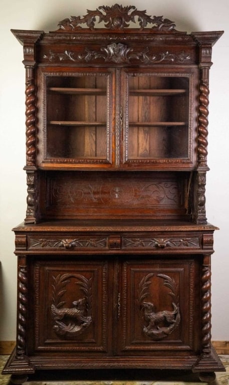 FRENCH RENAISSANCE REVIVAL HUNTING CABINET: French Renaissance Revival hunting cabinet with carved barley twist column decorations, elaborately carved crest, hunting dog carvings, inset carved panels, bun feet, and carved backsplash. Approximat