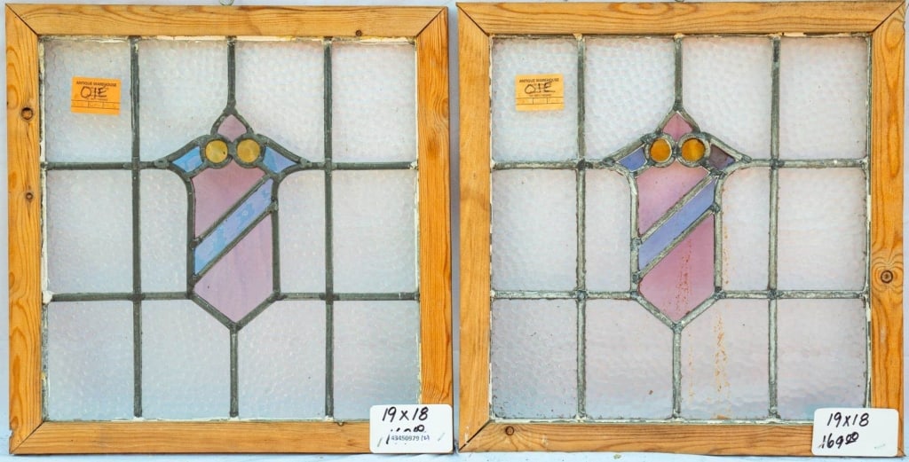 PAIR OF FRENCH STAINED GLASS PANELS: Pair of French stained glass panels with shield-shaped stained glass medallions, set within colorless leaded glass panels. Approximate dimensions: h. 19", w. 18" Disclaimer: This is an online court or
