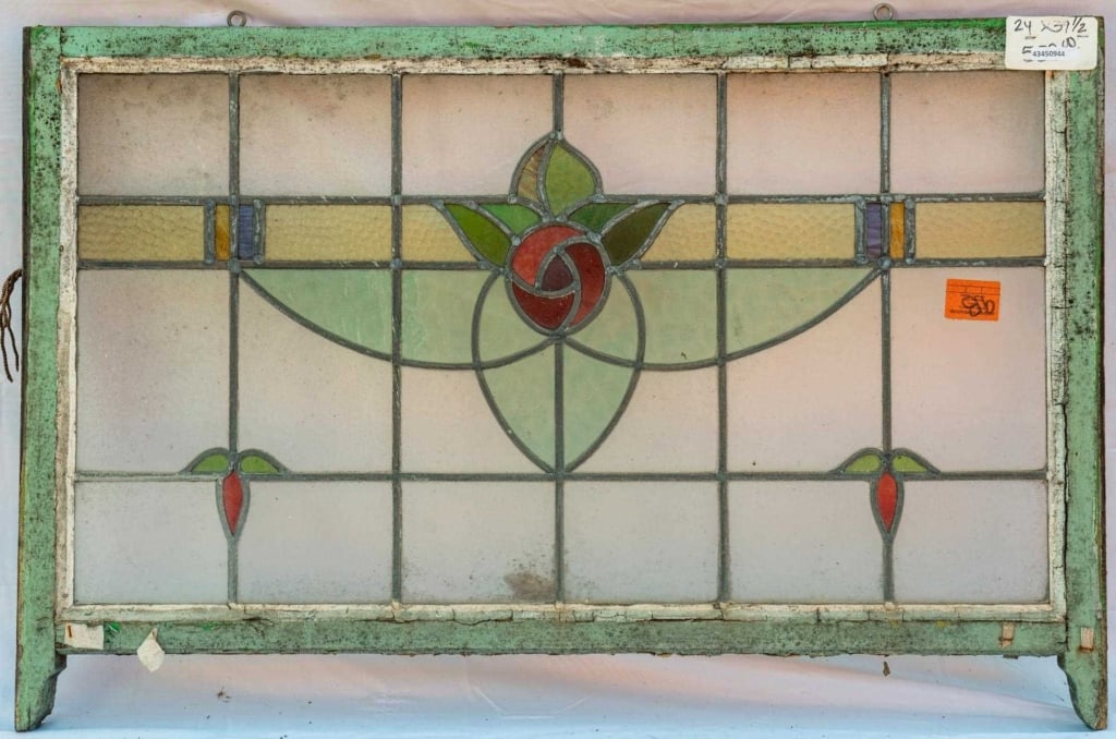 FRENCH ART NOUVEAU STAINED GLASS PANEL: French Art Nouveau stained glass panel with a rose and leaf motif set within leaded stained glass panels. Approximate dimensions: h. 24", w. 39.5" Disclaimer: This is an online court ordered bankruptc