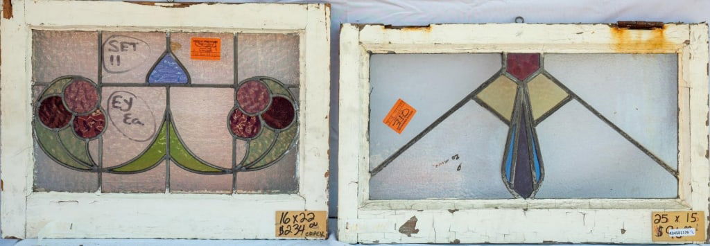 TWO CONTINENTAL STAINED GLASS PANELS: Two Continental stained glass panels, one with a floral motif and the other with a geometric motif. Approximate dimensions: h. 16", w. 22" Disclaimer: This is an online court ordered bankruptcy sale.