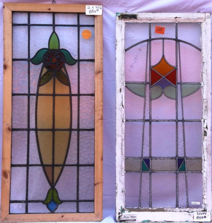 TWO ANTIQUE STAINED GLASS WINDOWS: Two antique stained glass windows: one with a natural wood frame and one with a white-painted wood frame. Approximate dimensions: h. 44", w. 20" Disclaimer: This is an online court ordered bankruptcy
